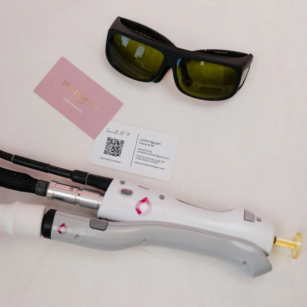 Laser goggles, the Candela GentleMax Pro handpiece and a Pink Diamond business card laid out on a white table